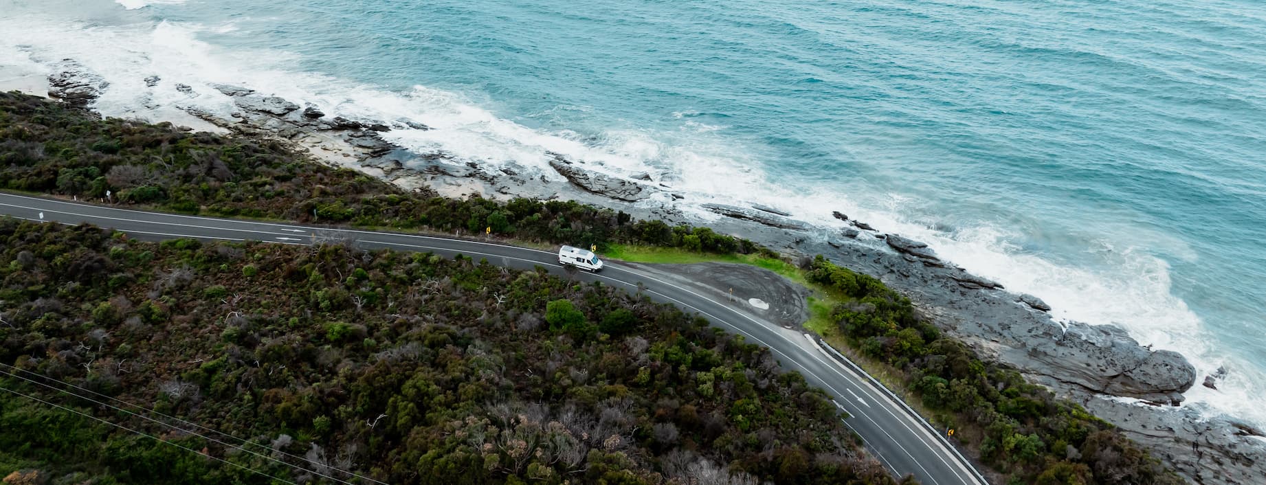 4WD towing a caravan on a dusty outback track